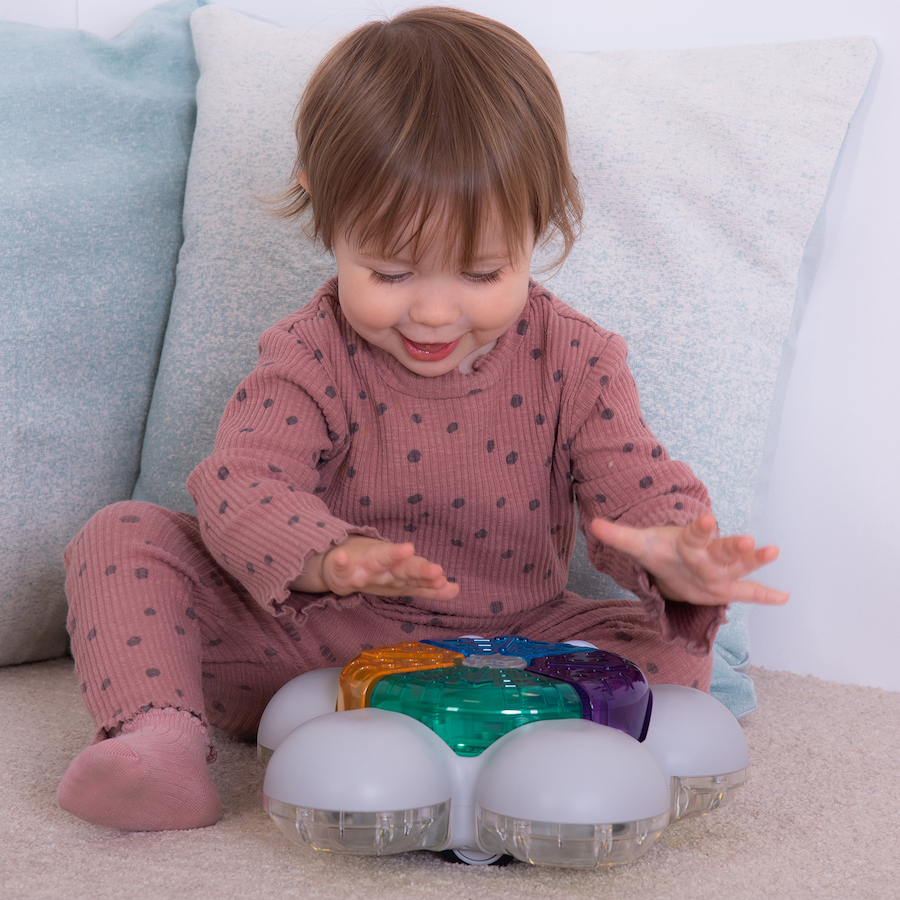 baby playing with TTS glow and go bot