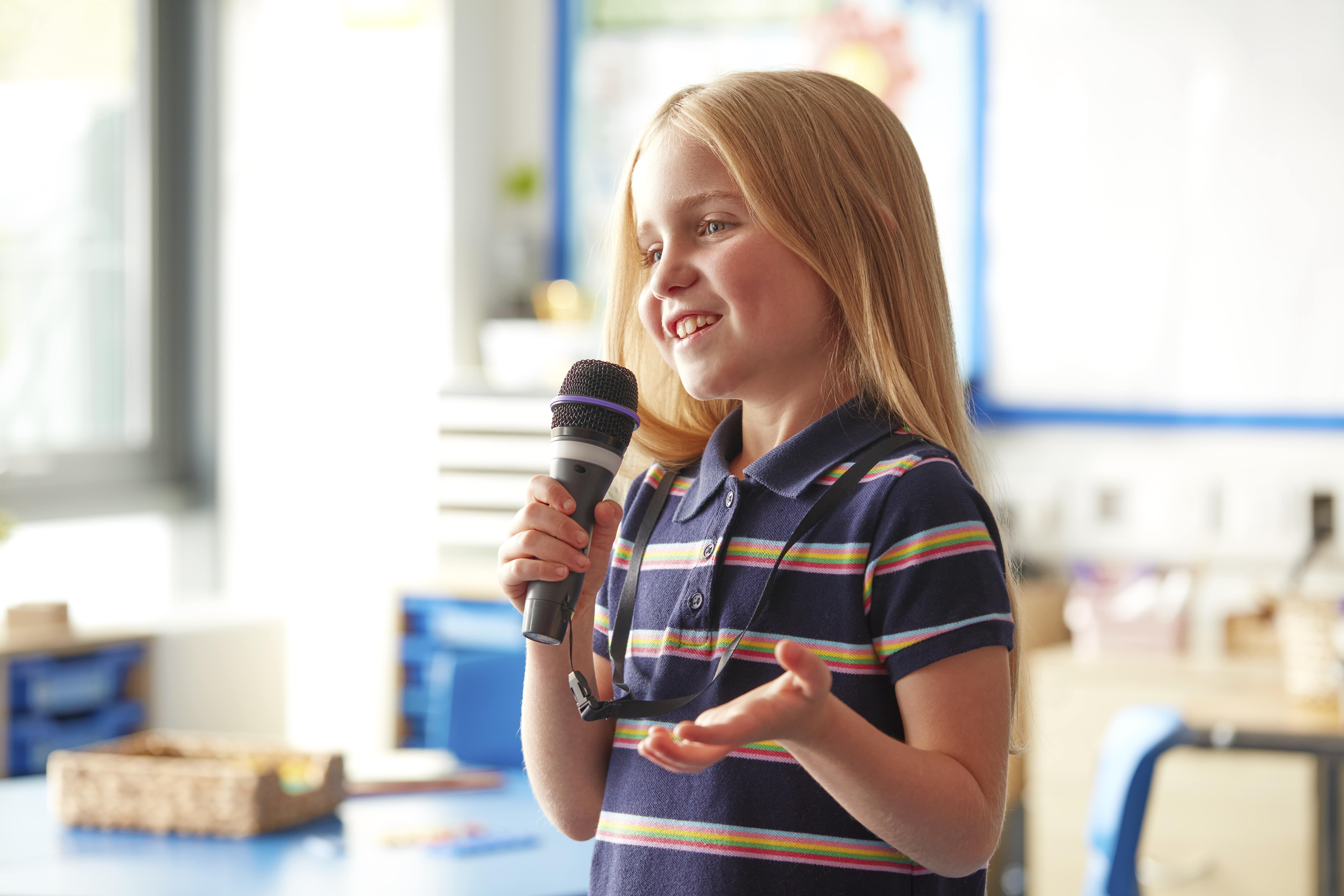 young girl talking into microphone