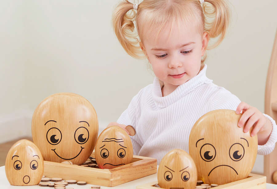 young girl playing with TTS emotional pebbles