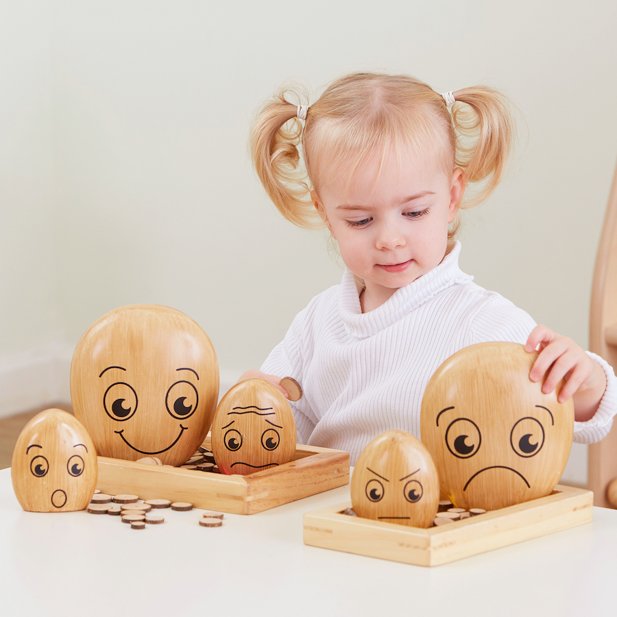 young girl playing with TTS emotional pebbles