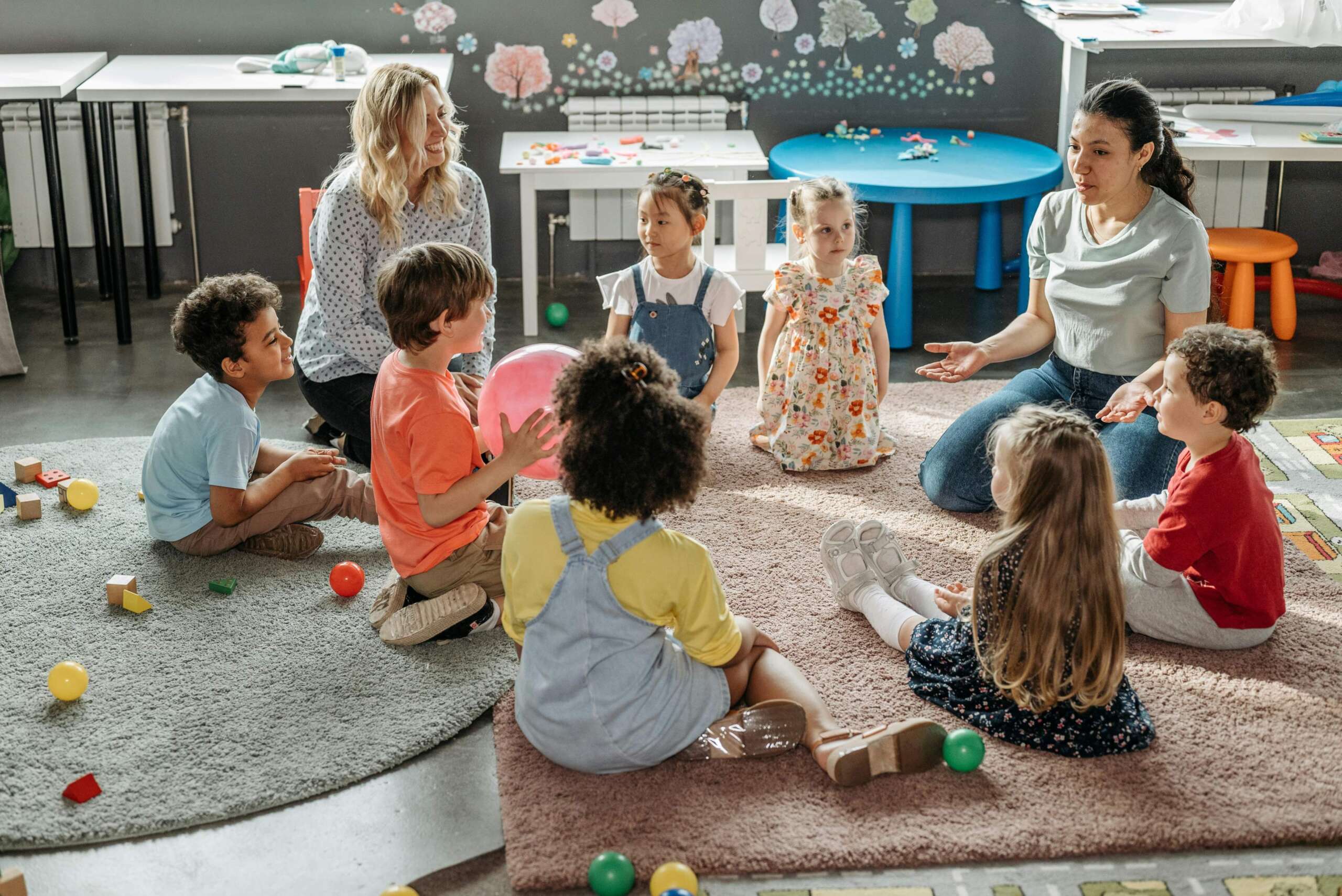 children sat in a circle on the floor
