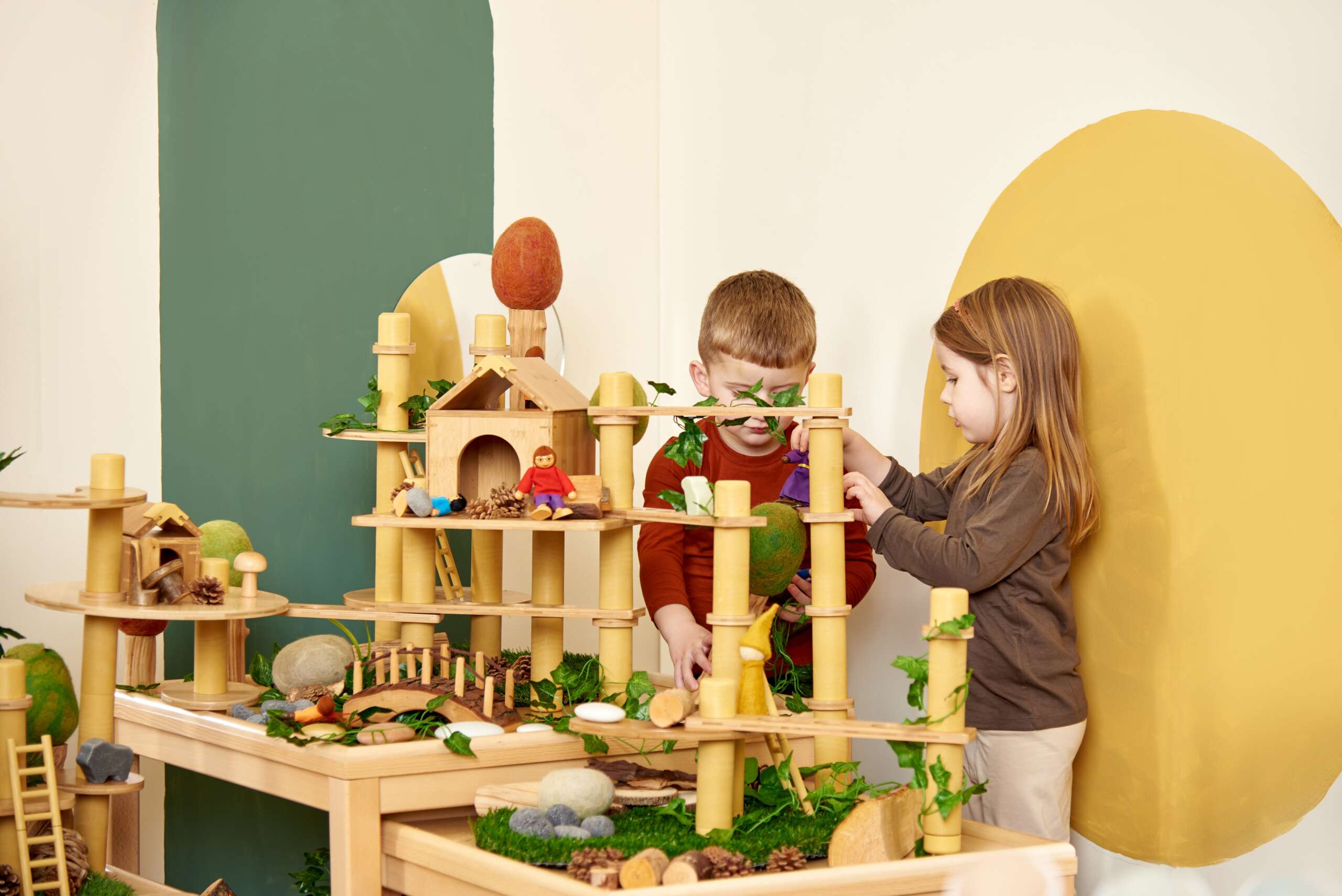 two children playing with a wooden toy inside