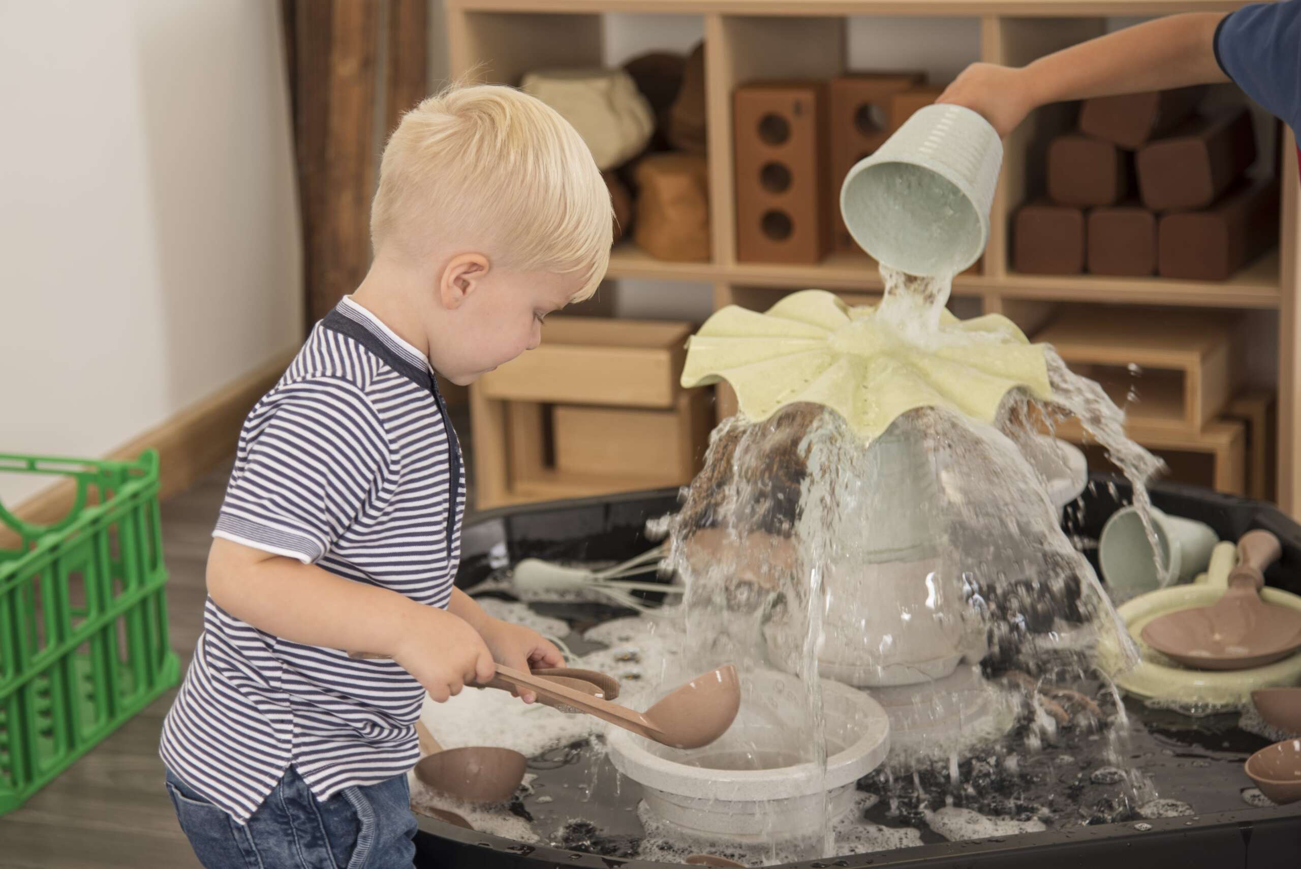 child in water play area inside